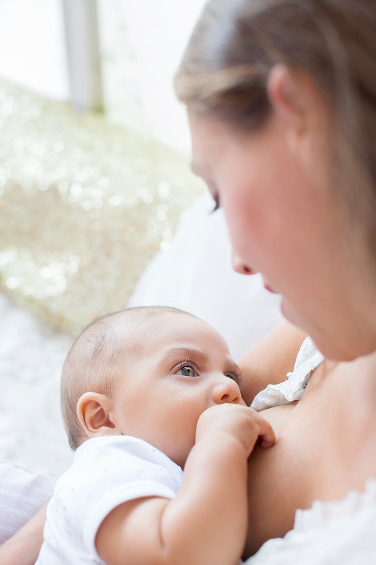 Mother breast-feeding baby boy