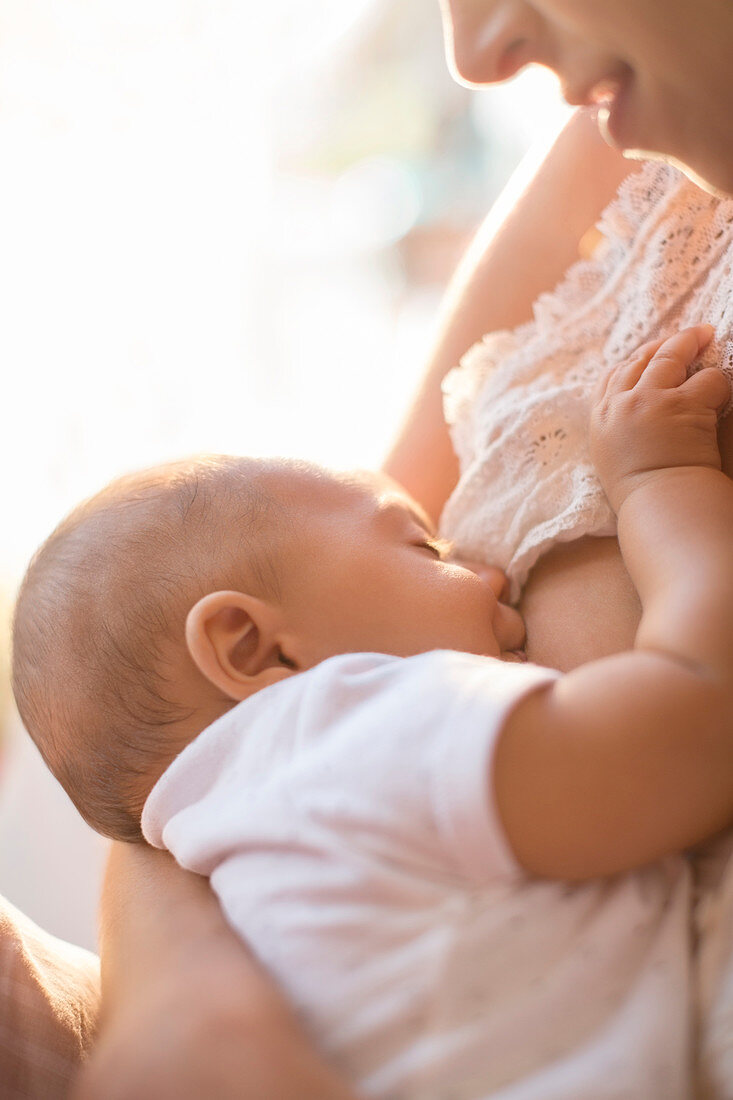 Mother breast-feeding baby boy