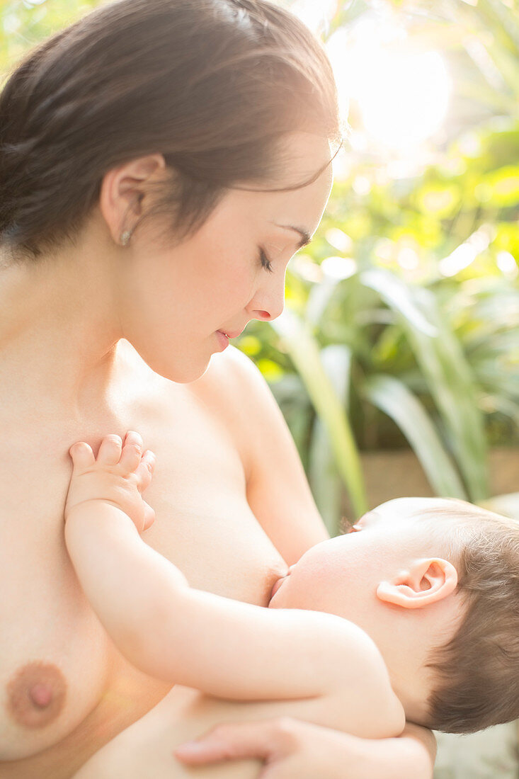 Mother breast-feeding baby boy