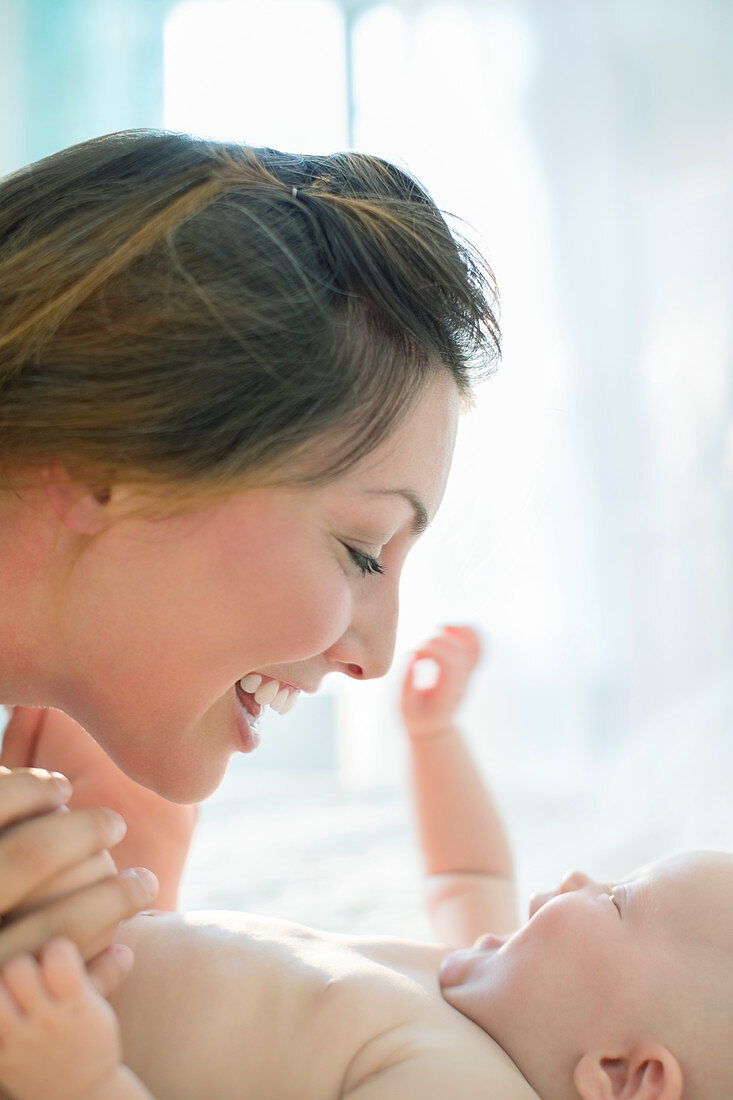 Mother playing with baby girl