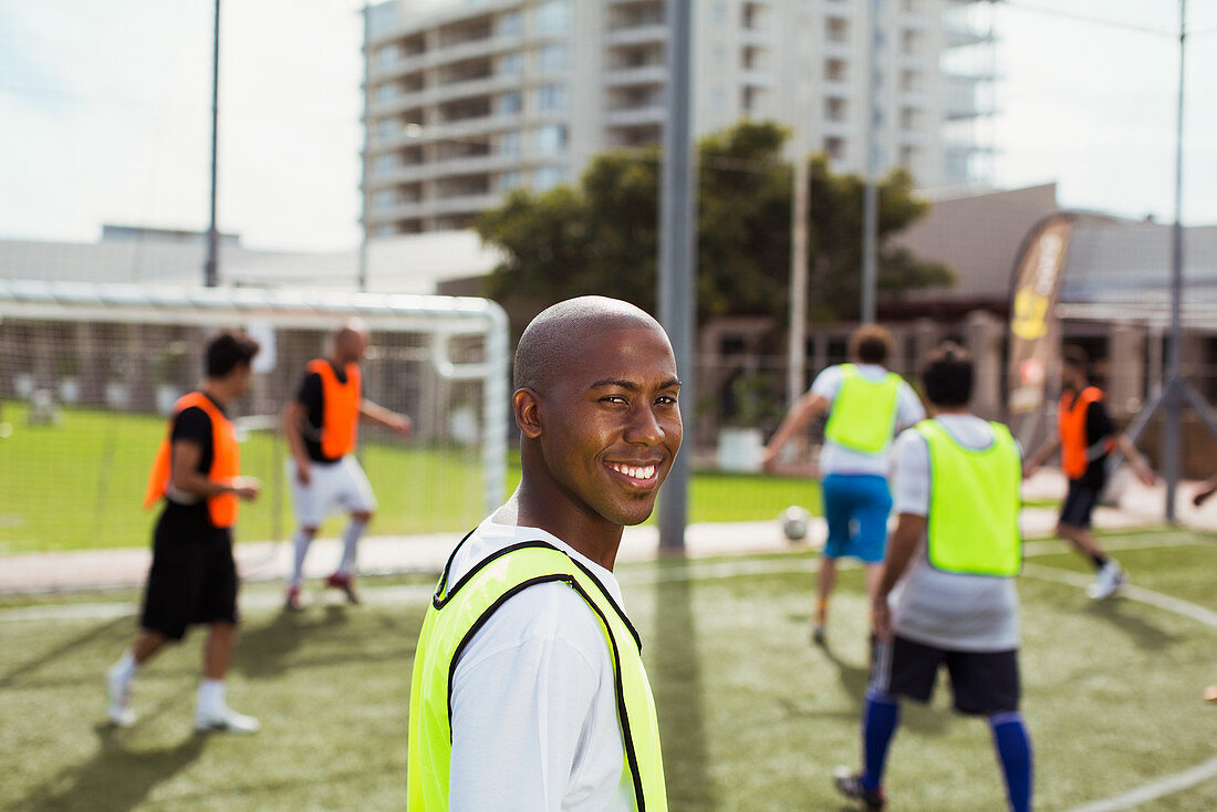 Soccer player smiling on field