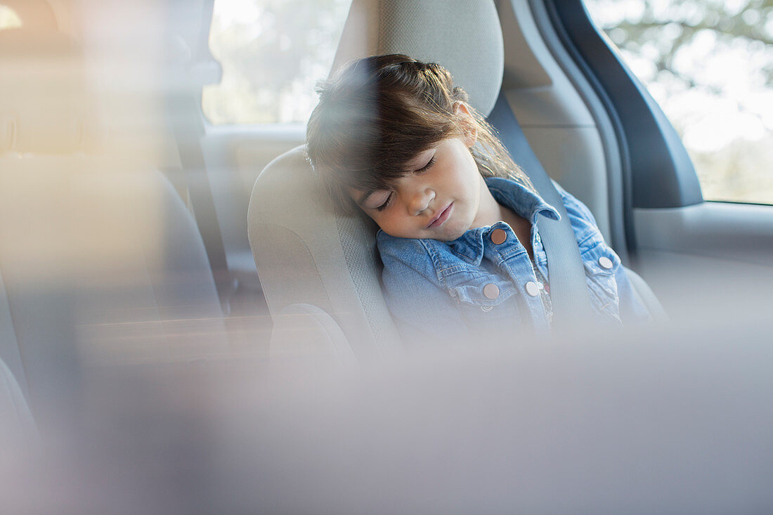 Girl sleeping in back seat of car