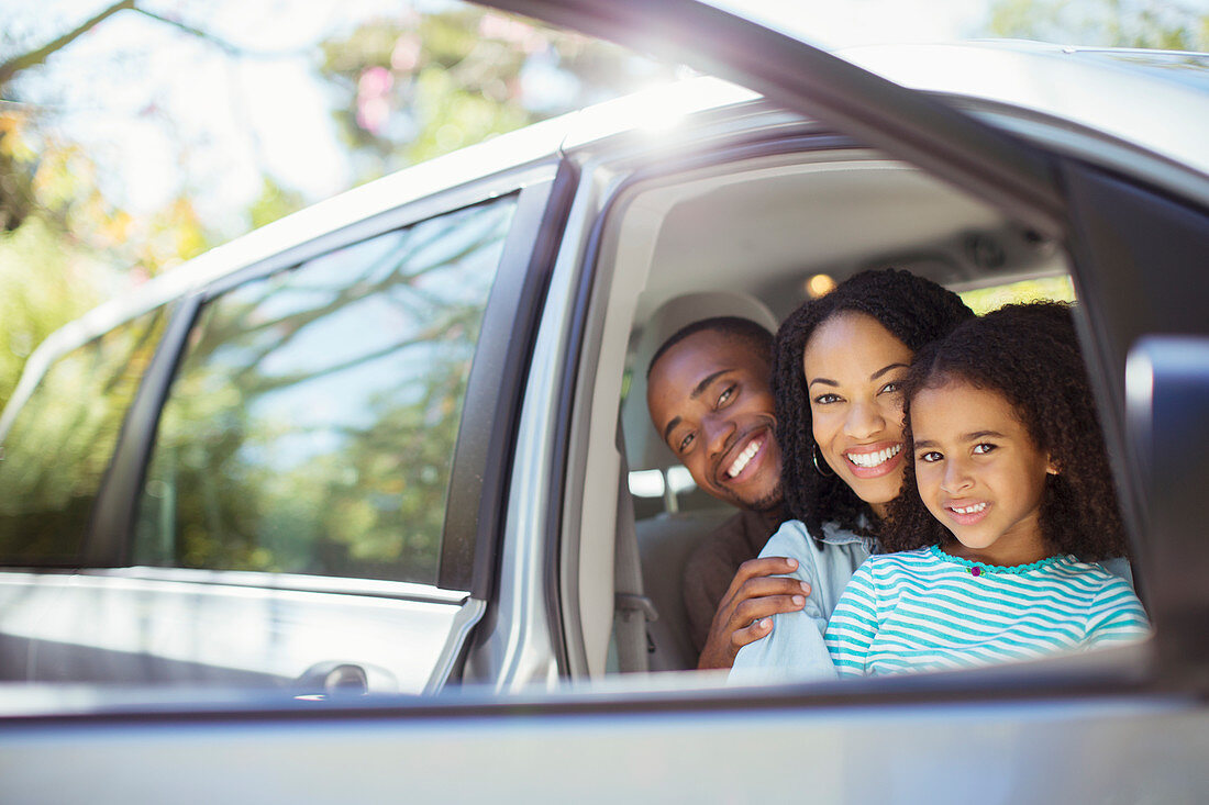 Portrait of happy family inside car