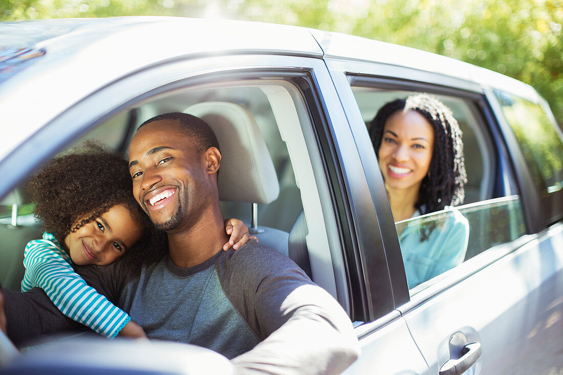 Portrait of happy family inside car