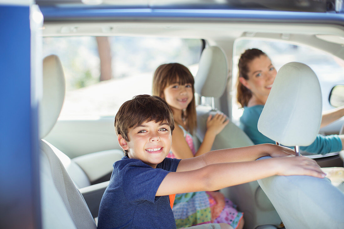 Portrait of happy family inside of car