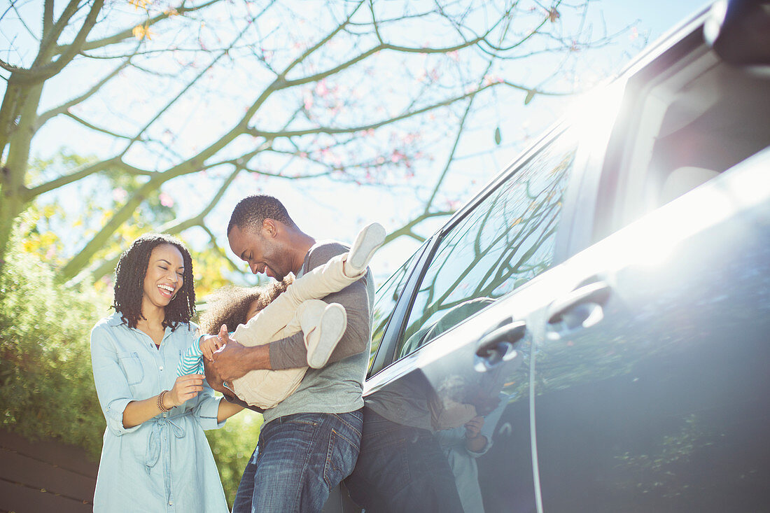 Happy family outside car