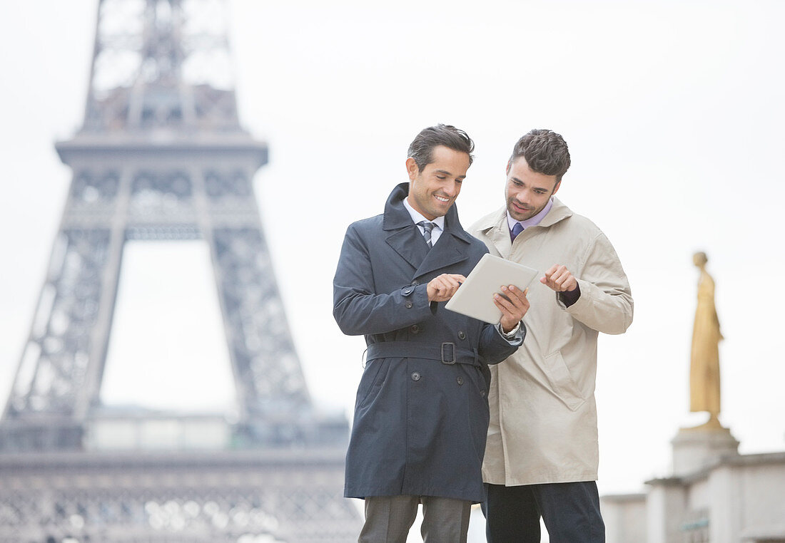 Businessmen using digital tablet in Paris