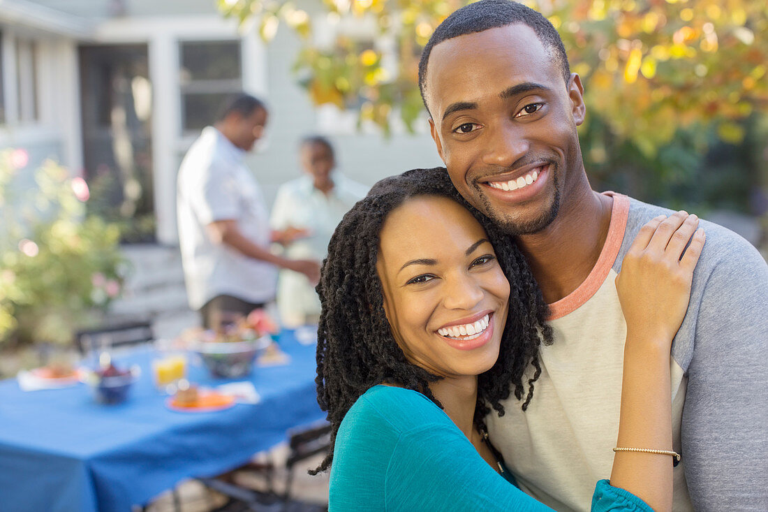 Portrait of happy couple near patio table