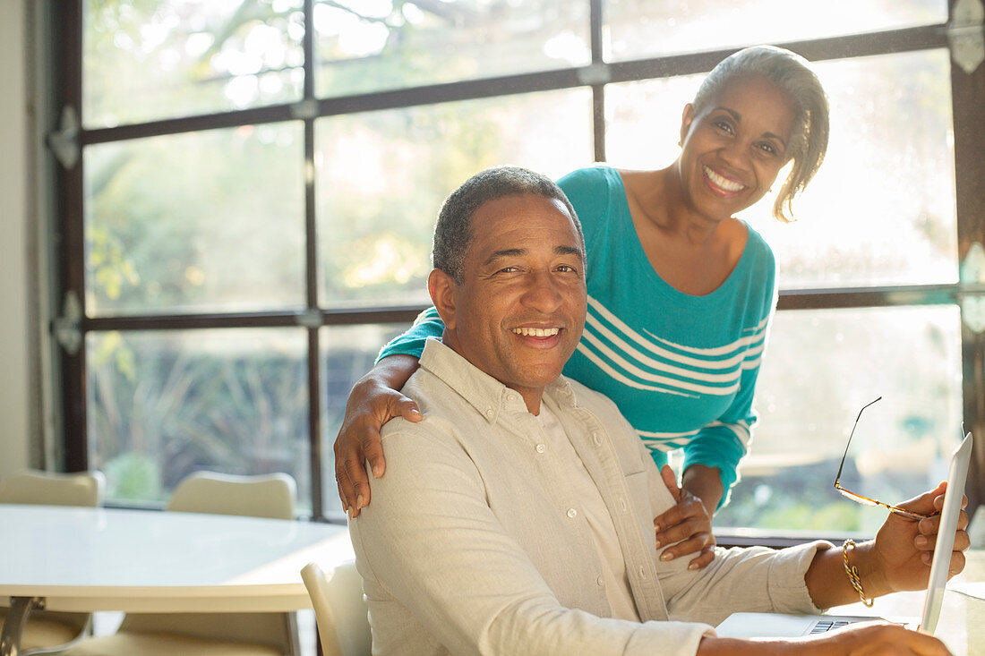 Smiling senior couple at laptop