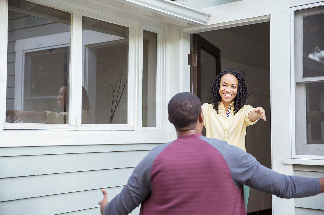 Enthusiastic woman greeting man