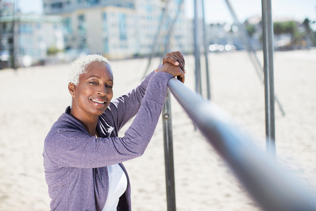 Woman leaning on bar at beach playground