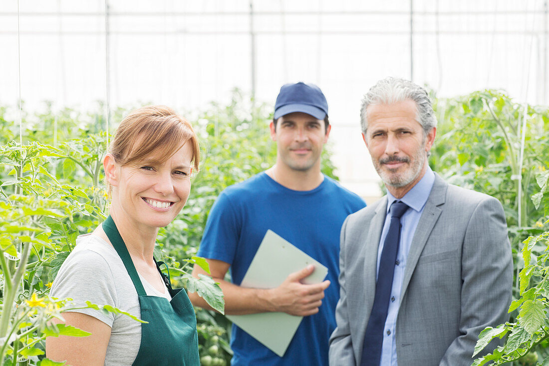 Business owner and workers in greenhouse