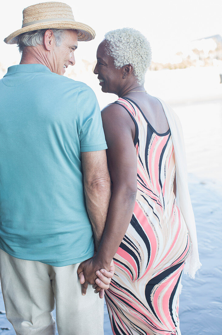 Senior couple holding hands and walking