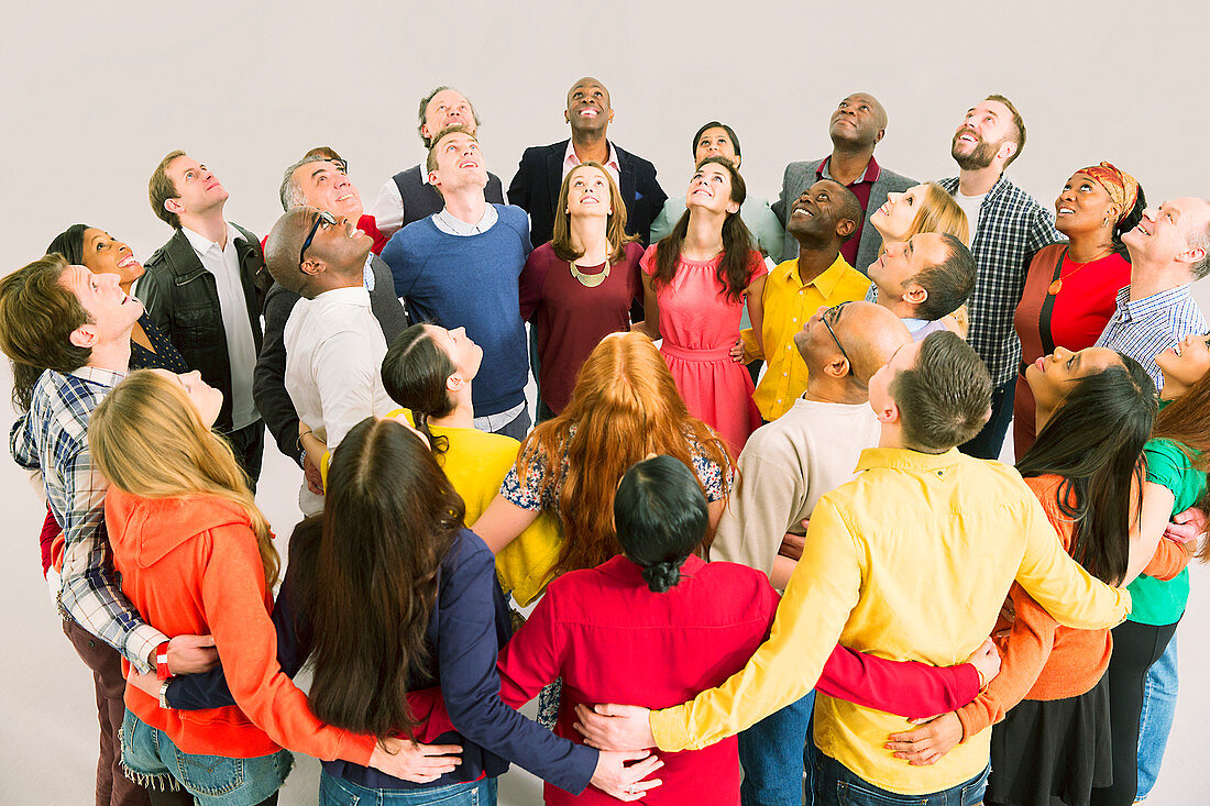 Business people looking up in huddle