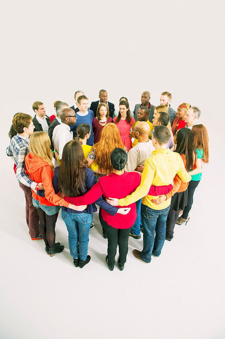 Diverse group forming huddle