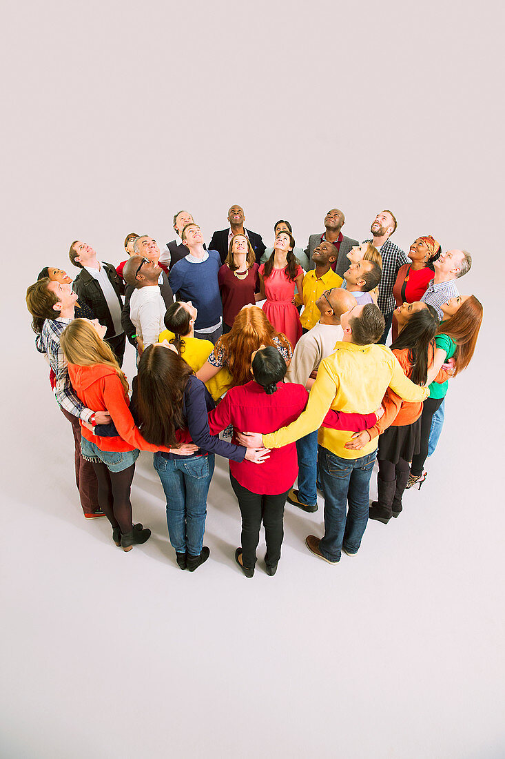 Business people looking up in huddle