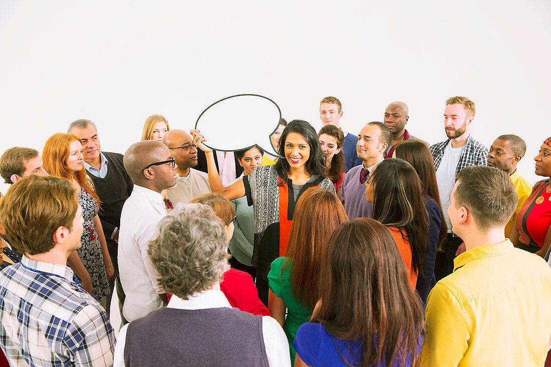 Businesswoman with speech bubble in crowd