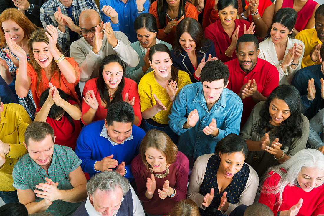 Diverse crowd clapping