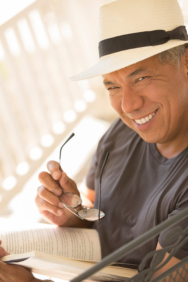 Portrait of smiling man reading book