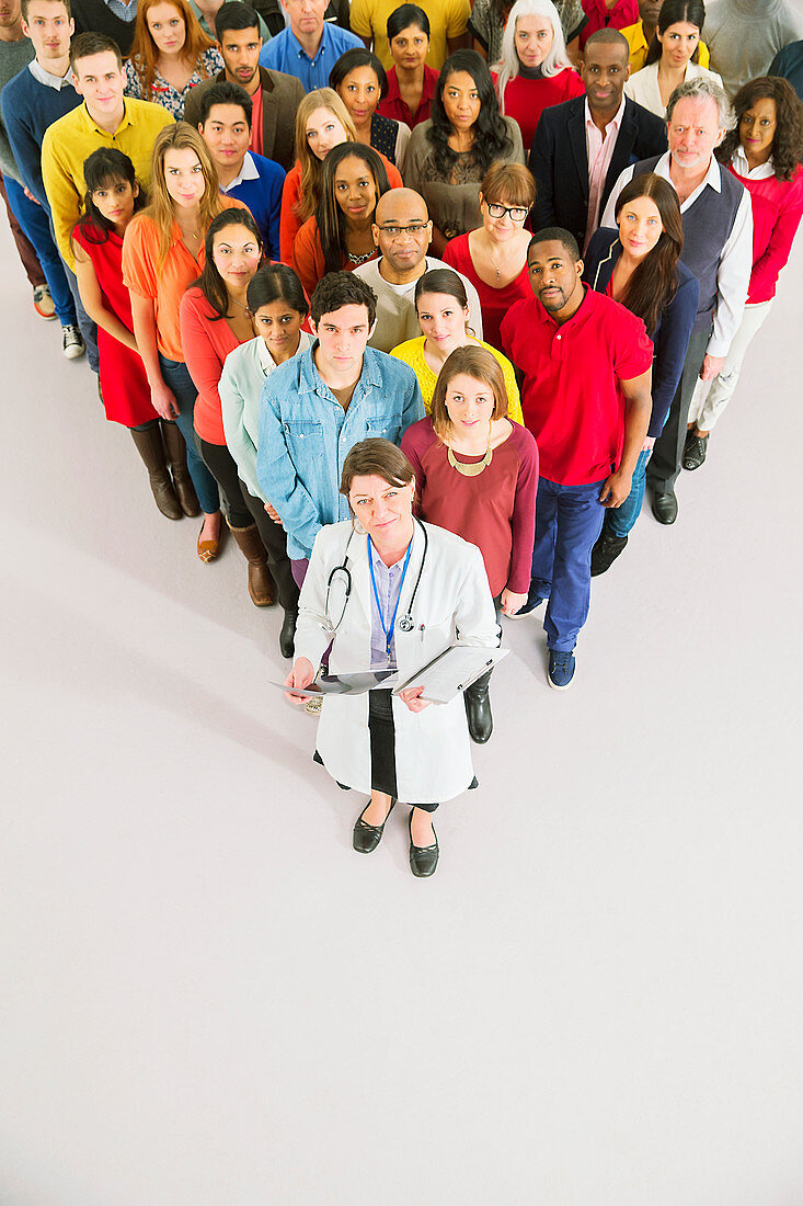 Doctor standing in front of diverse crowd