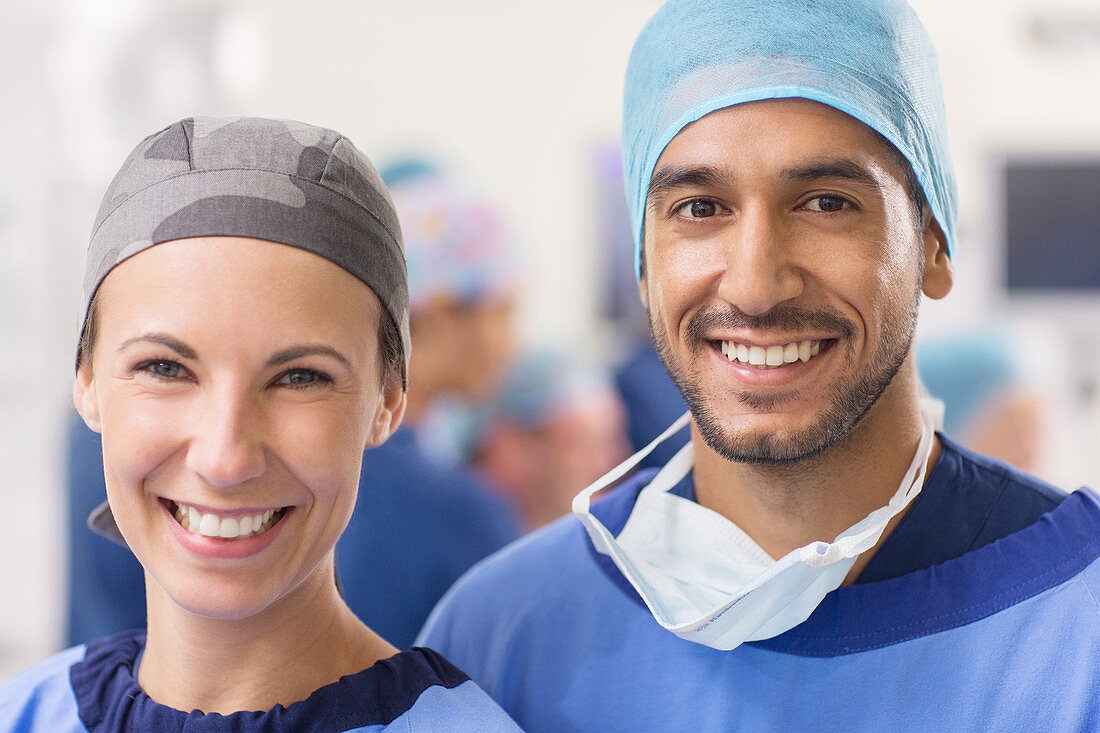 Smiling doctors wearing surgical caps