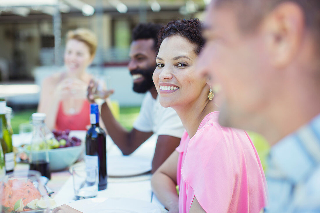 Woman smiling at table outdoors