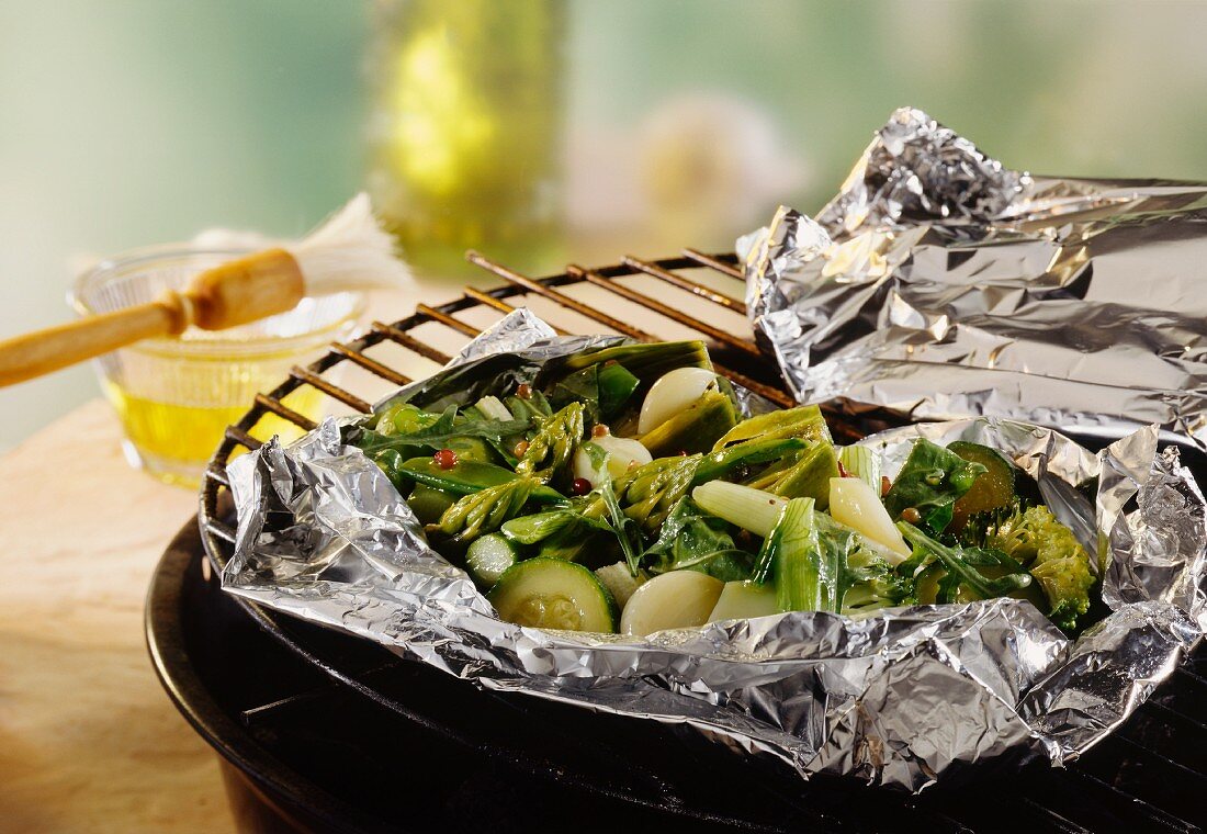 Vegetable parcel (foil with mixed green vegetables) on barbecue