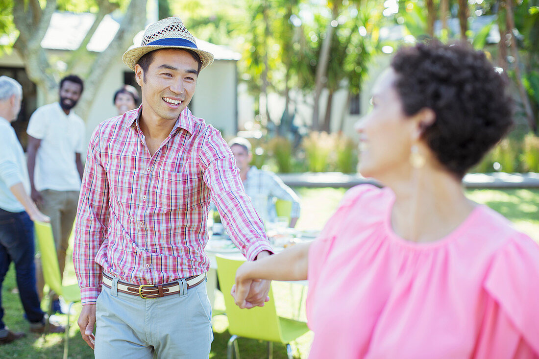 Couple holding hands at party