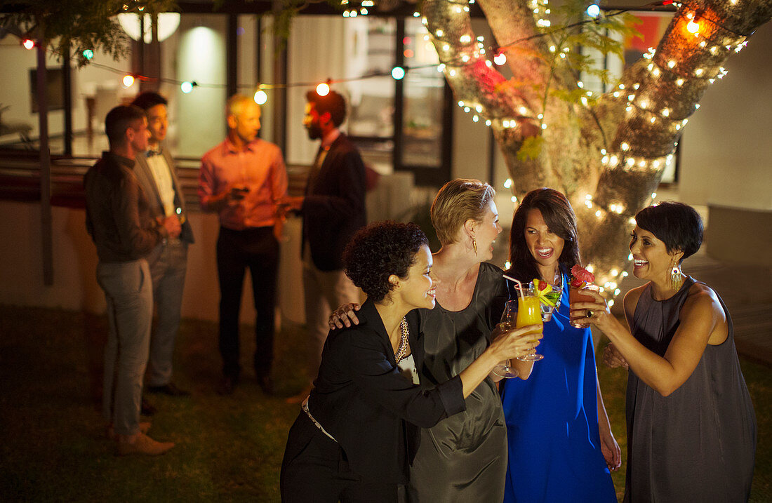 Friends toasting each other at party