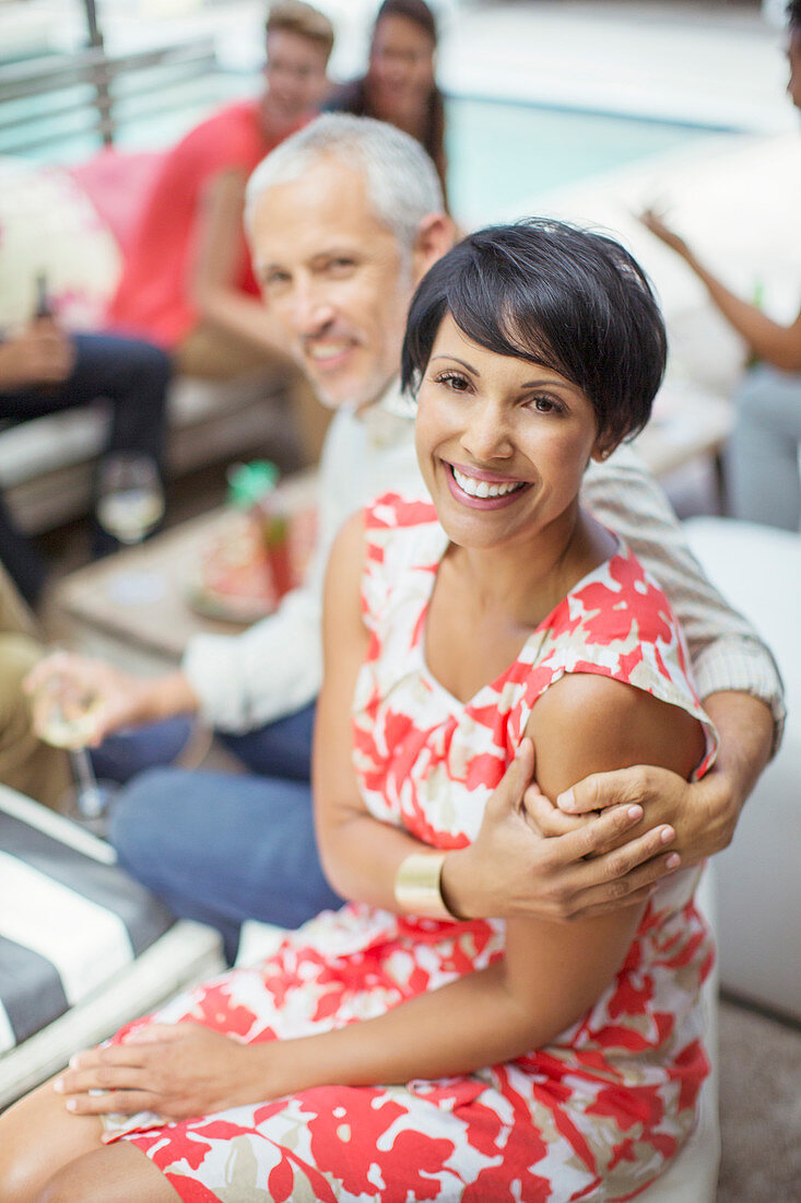 Couple hugging at party