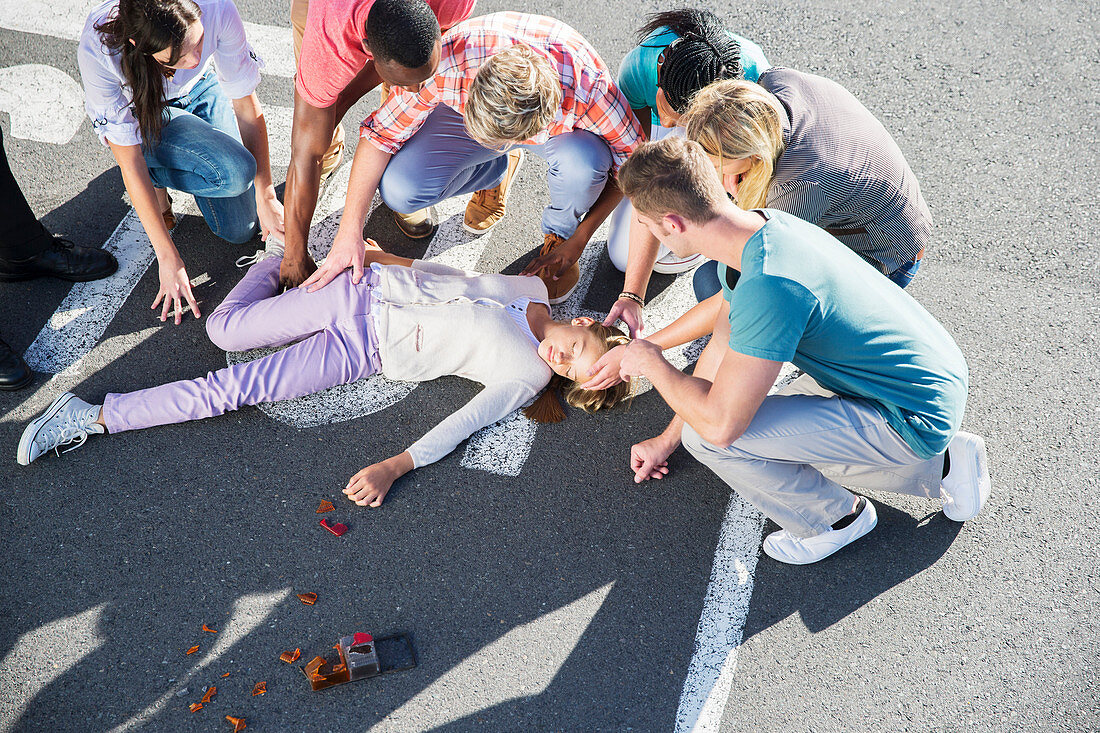 People rushing to injured girl on street