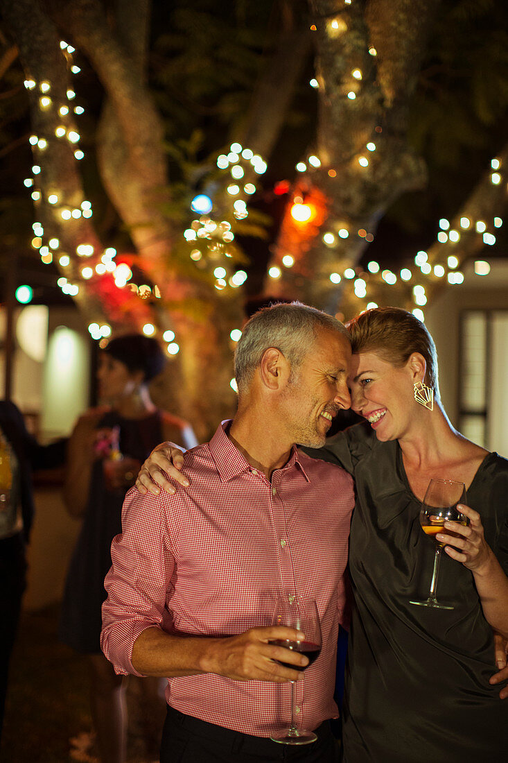 Couple hugging at party