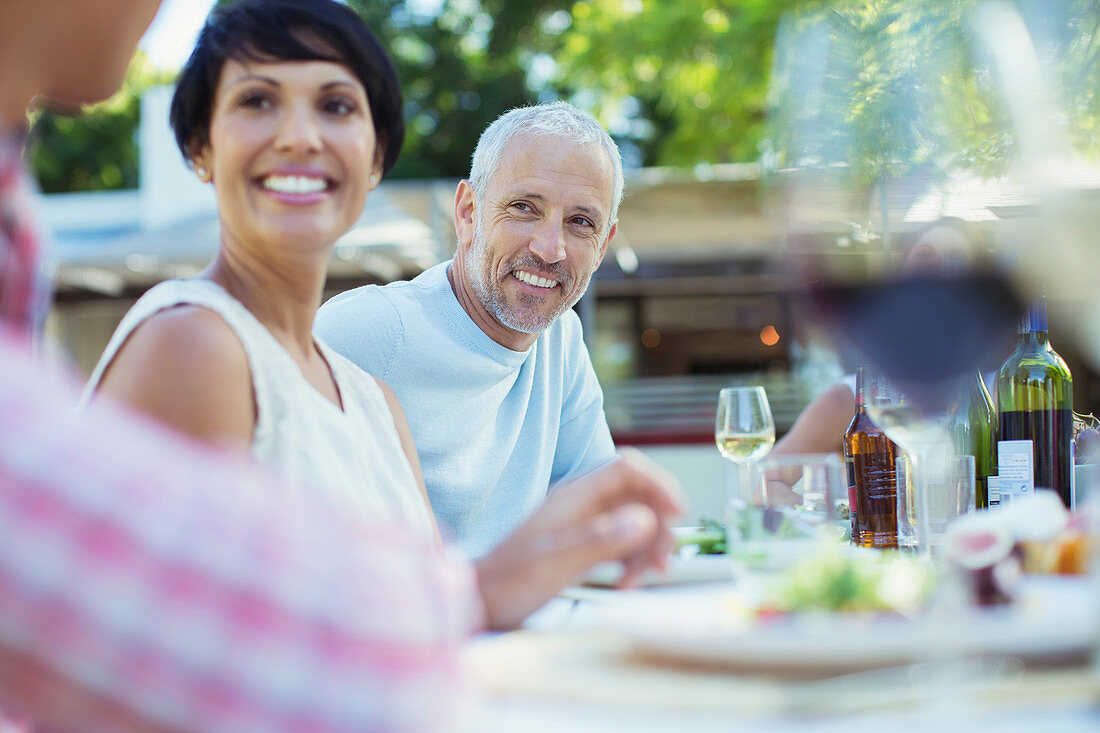 Couple smiling at table outdoors