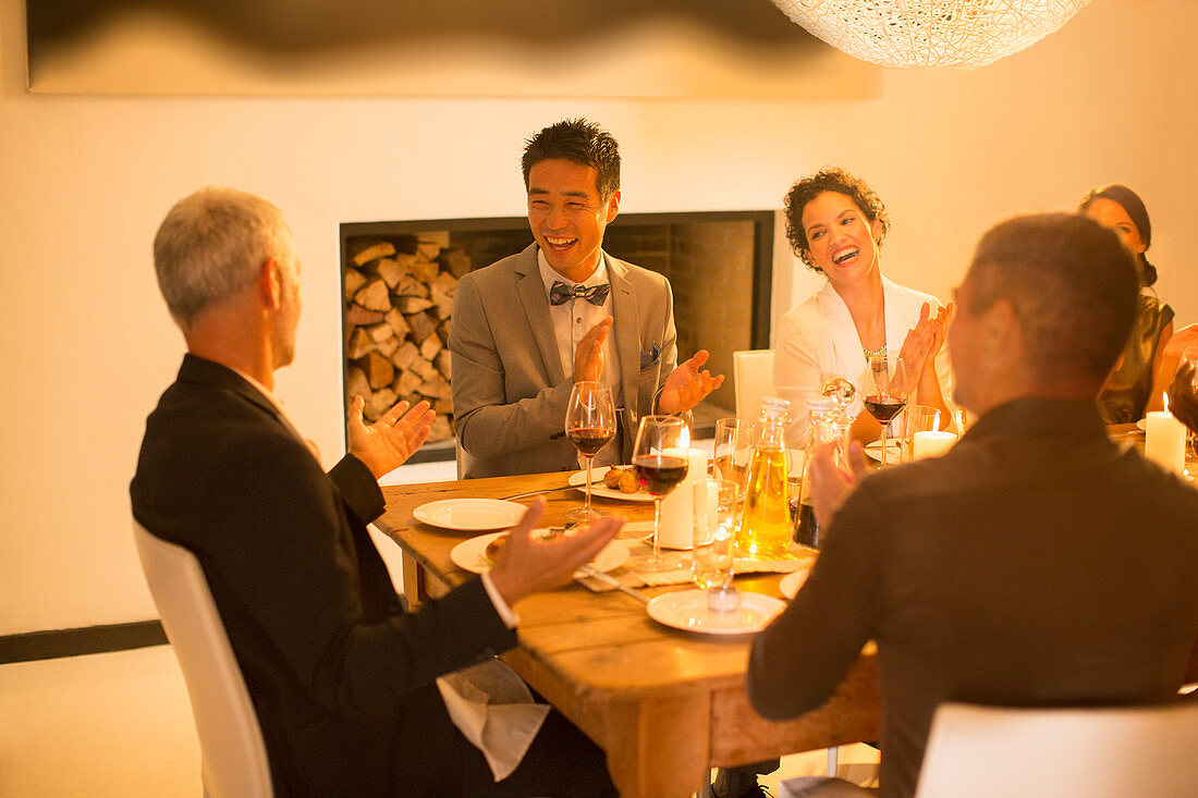 Friends applauding at dinner party