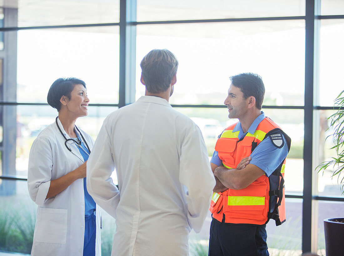 Doctors and paramedic talking in hospital