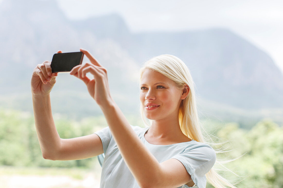 Woman taking pictures in rural landscape