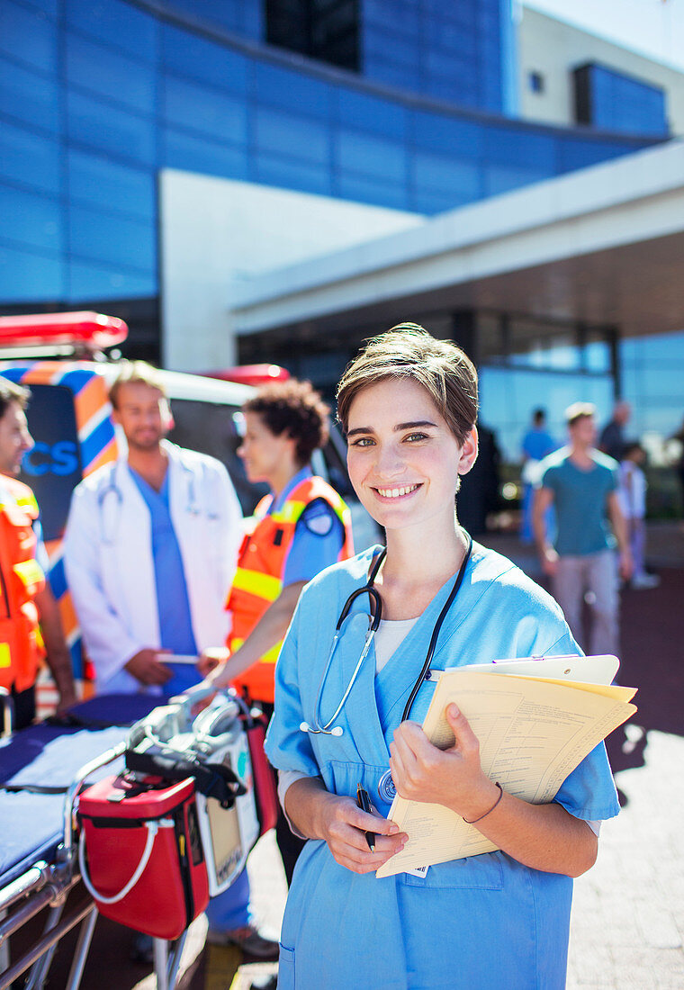 Nurse smiling outside hospital
