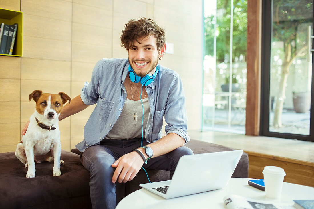 Man petting dog in office