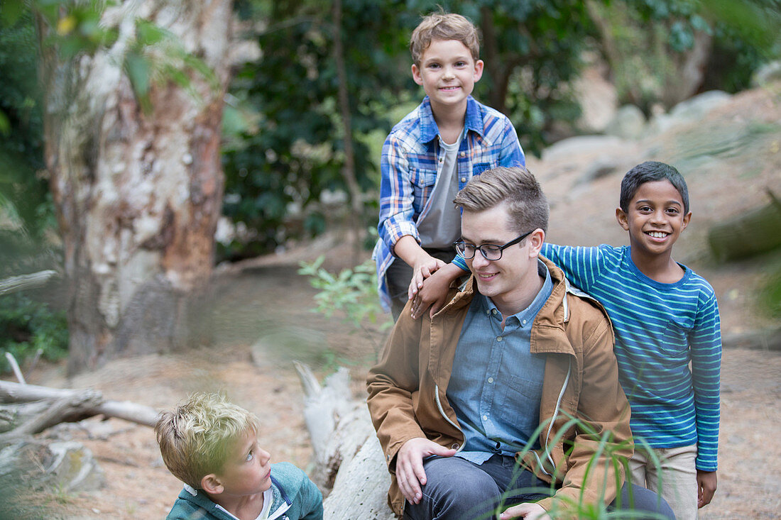 Students and teacher playing in forest