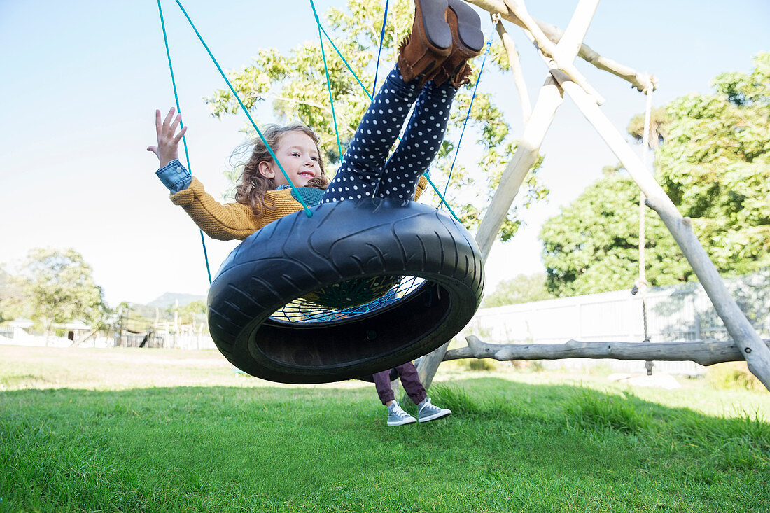 Children playing on tire swings