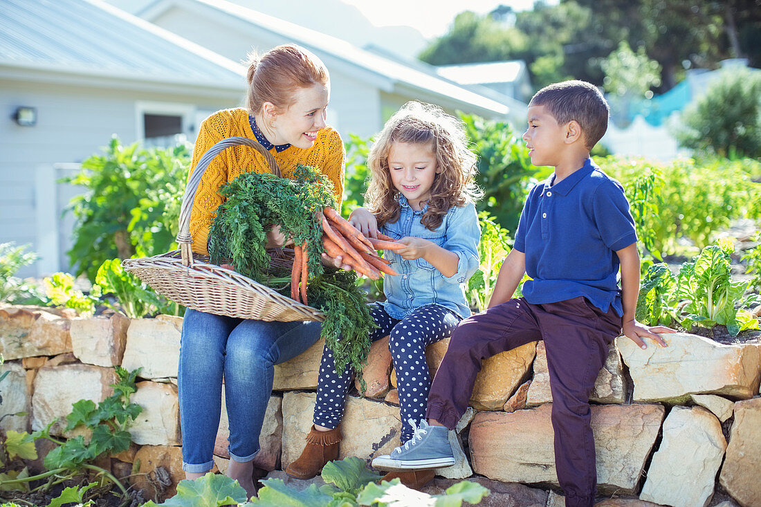 Teacher and students in vegetable garden