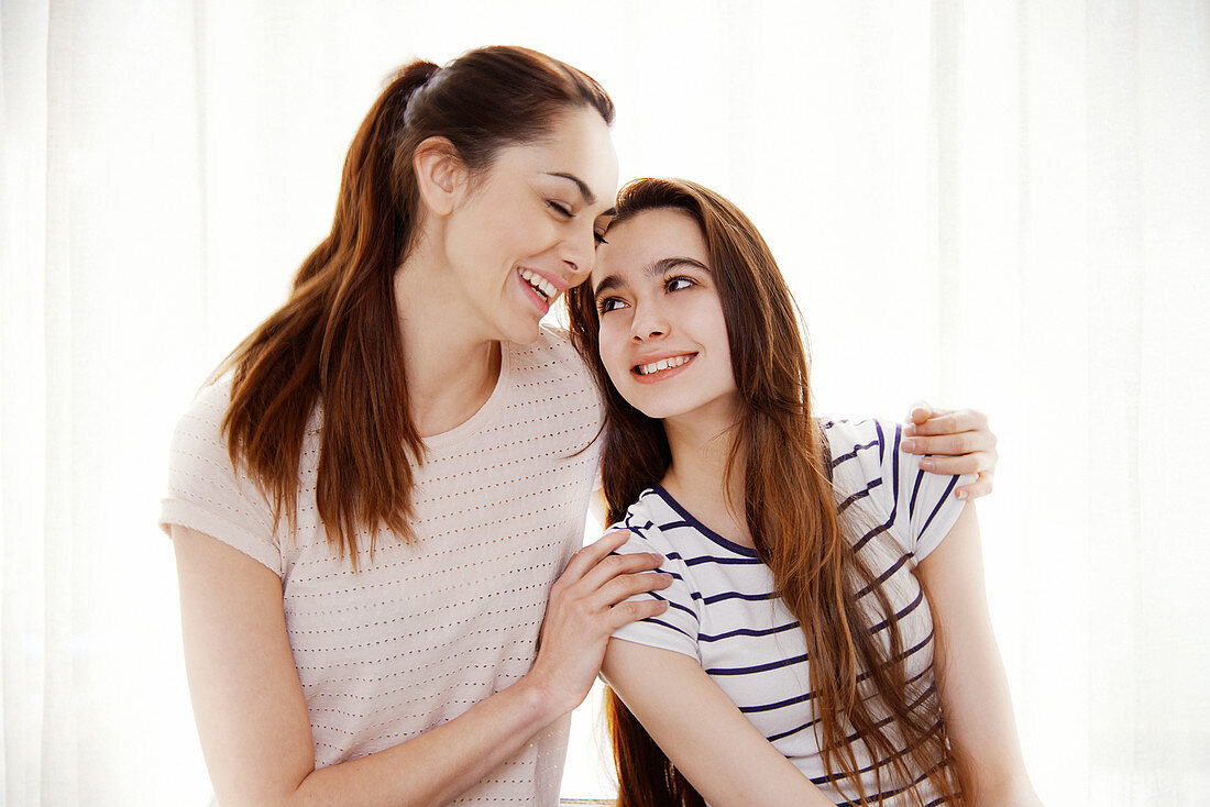 Mother and daughter hugging