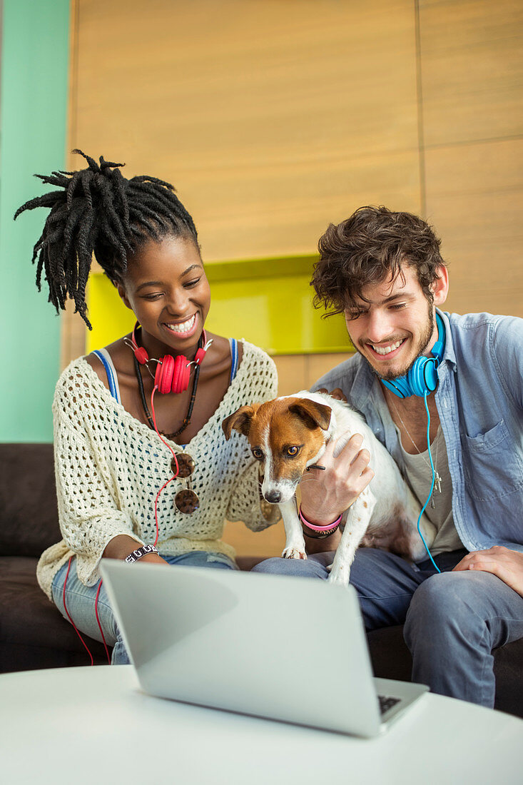 People and dog working in office