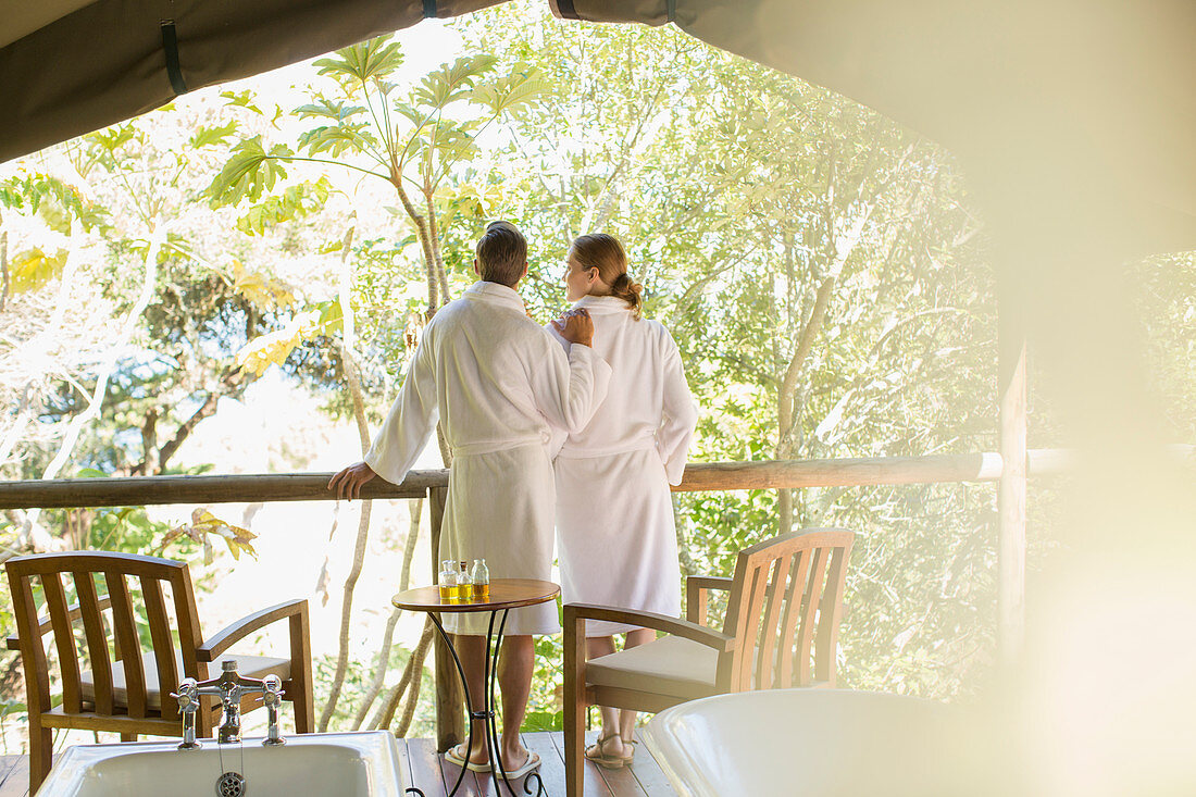 Couple in bathrobes standing in spa