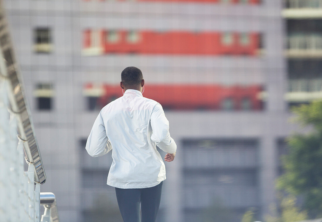 Man running through city street