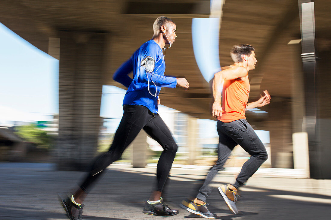 Men running through city streets together