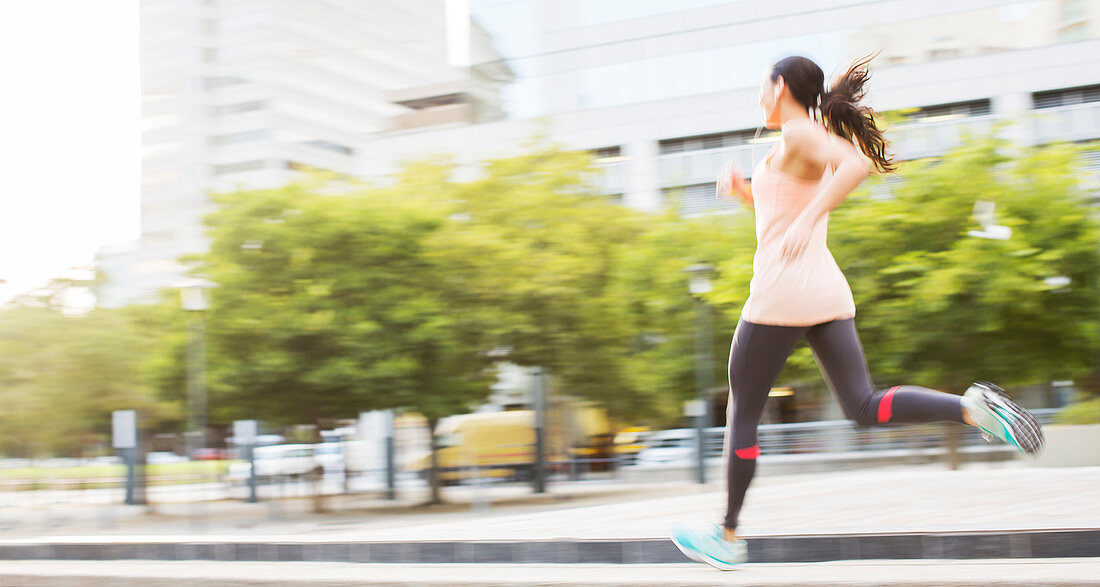 Woman running through city streets