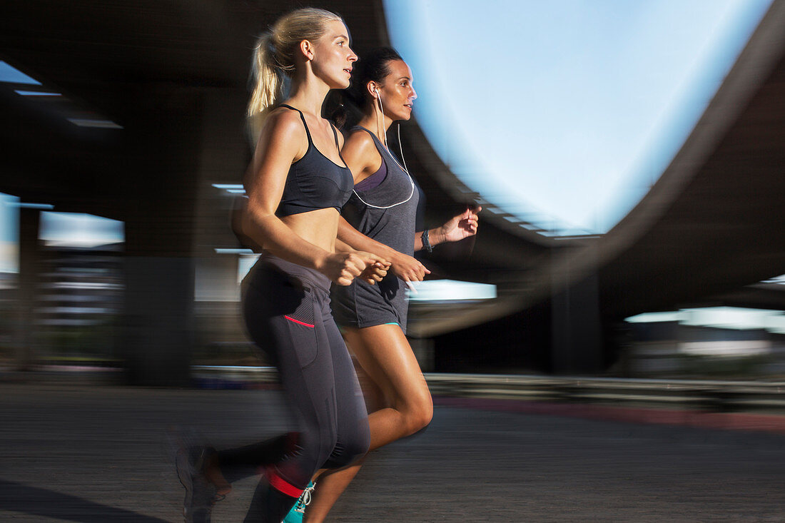 Women running through city streets