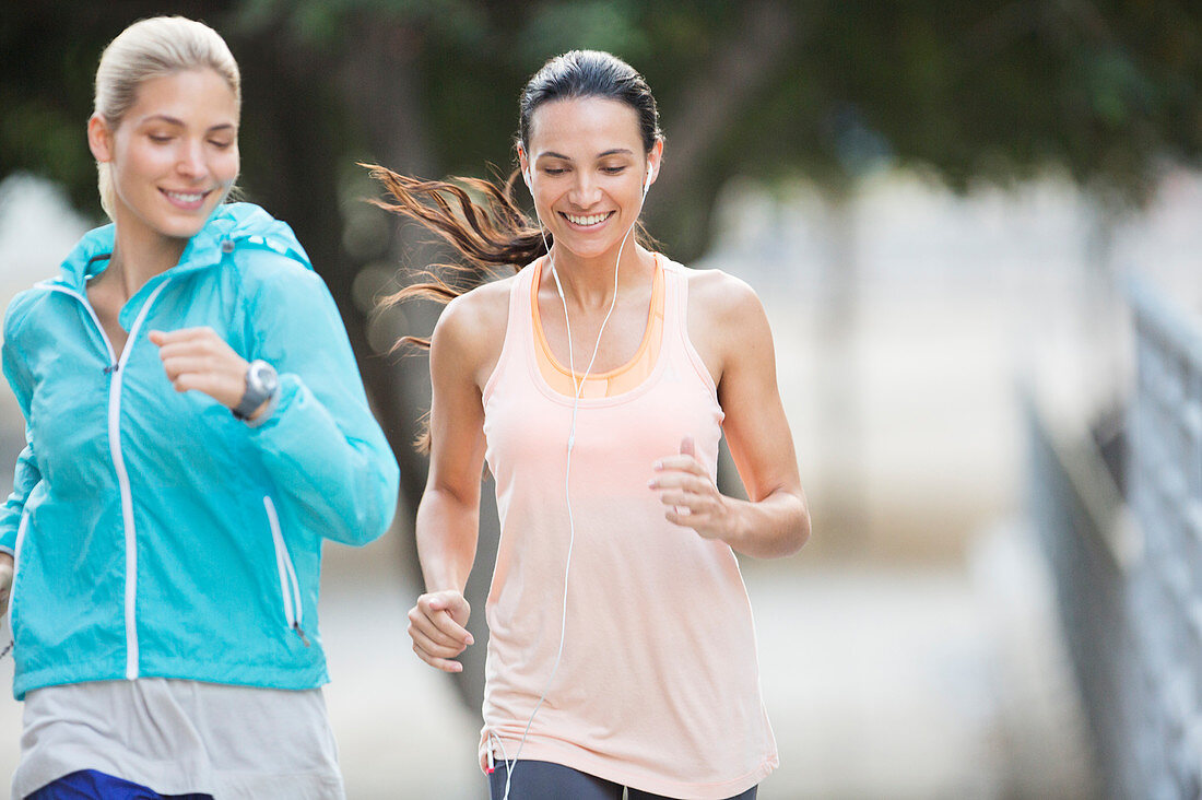 Women running through city streets