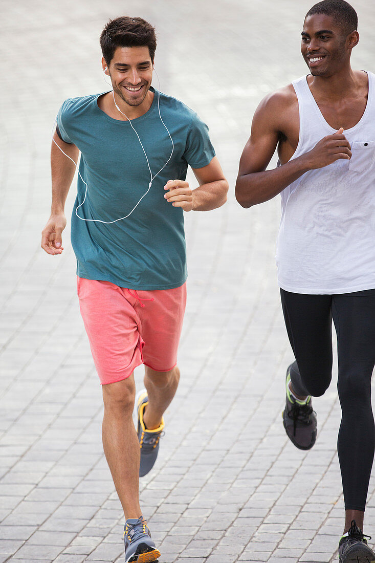 Men running through city streets together